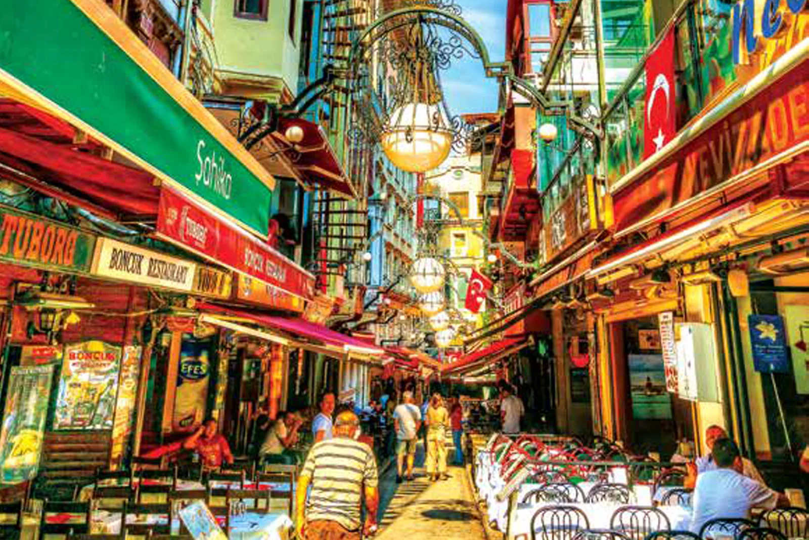 Restaurants and outdoor tables on a narrow street