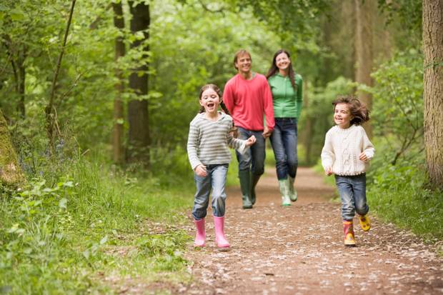 A family walking along a wooded path