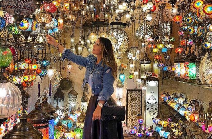 A visitor browsing colourful lamps in an Istanbul market